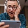 Copia de surprised-man-in-headphones-using-mobile-phone-whi-2021-09-01-07-24-44-utc